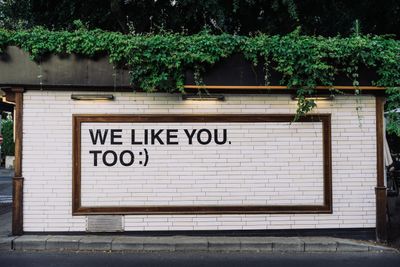 Side of a building with the words: We like you too.