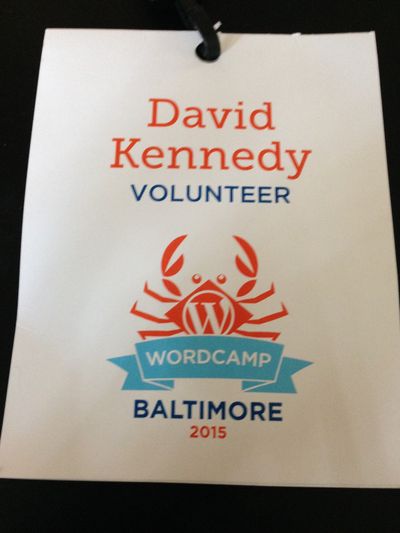 WordCamp Baltimore 2015 conference badge with a cartoon crab in the center and the words David A. Kennedy, volunteer.