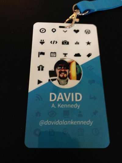 Blue and white conference badge with social media icons and the words David A. Kennedy.