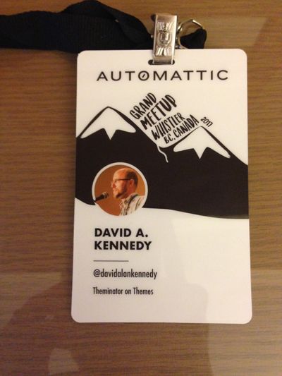 Automattic Grand Meetup conference badge with avatar, mountains in background and the words David A. Kennedy.