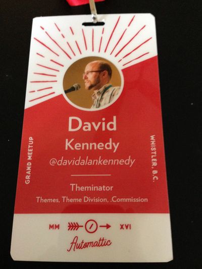 Automattic Grand Meetup 2016 conference badge with red and white design and the words David A. Kennedy, Automattic Grand Meetup 2016.