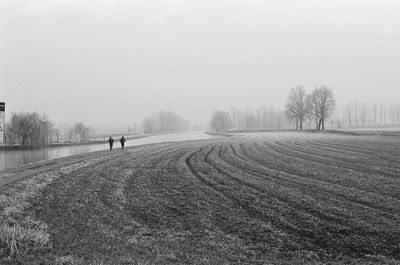 Joggers jogging in a field.