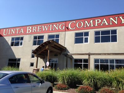 A visit to the Uinta Brewing Company, showing the company sign on the front of a stone building.