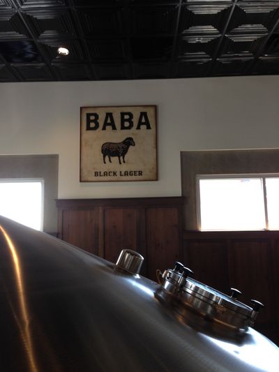 Baba, a black lager, is one of the beers that Uinta makes. Displayed on a sign with a light background, black lettering and a black sheep in the center.
