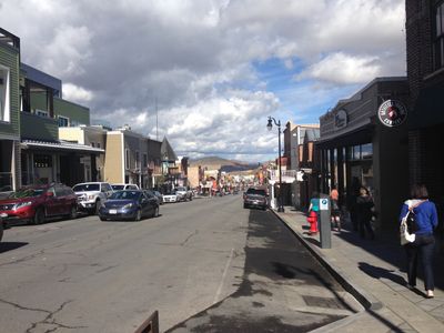 Main street of Park City, Utah, showing several shops and cars parked on a street.