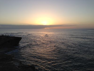 The Hawaiian shoreline near Lihue with the sun shining during sunrise.