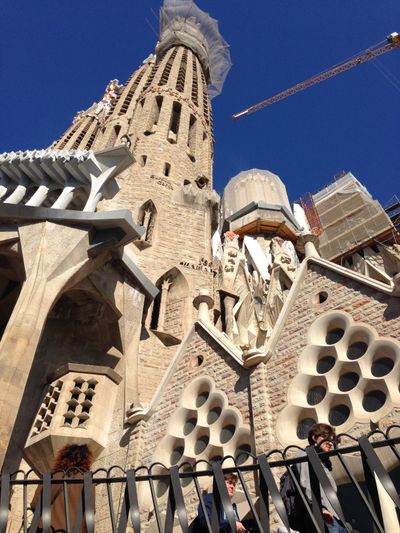 A view of La Sagrada Familia, an ornate church in Barcelona, Spain, from the street.
