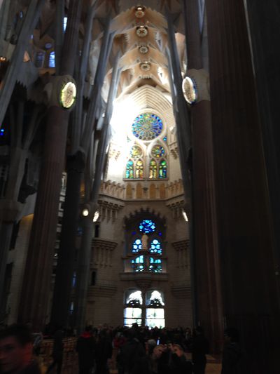 A view of the ceiling, which includes stonework and stained glass, in La Sagrada Familia, an ornate church in Barcelona, Spain.