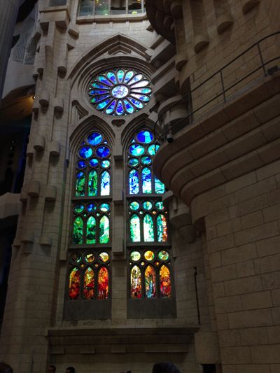 A stained glass window of blue and red in La Sagrada Familia, an ornate church in Barcelona, Spain.