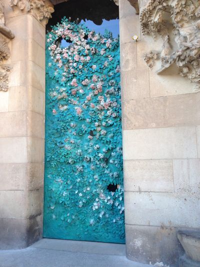 A blue door on La Sagrada Familia, an ornate church in Barcelona, Spain.