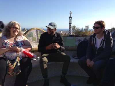 A few theme wranglers in Parc Güell sitting on a bench and chatting.