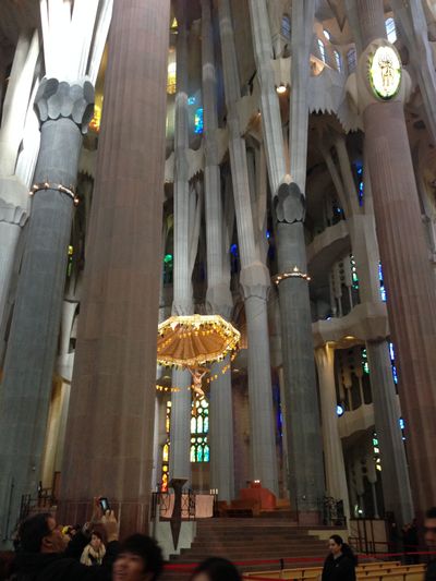 Large, stone columns in La Sagrada Familia, an ornate church in Barcelona, Spain.