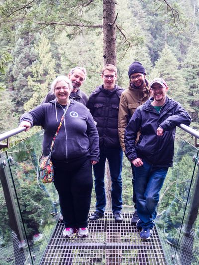 Several themers on a platform above a forest overlooking the Capilano River, in Capilano Suspension Bridge Park.