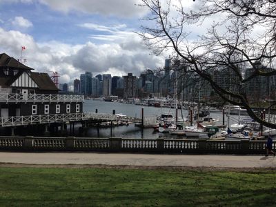 A view of the harbor in Stanley Park, showing buildings and boats, in Vancouver.