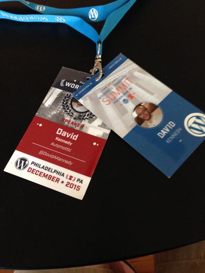 WordCamp US 2015 and Community Summit conference badges, both with rectangular designs, WordPress logos and the words David A. Kennedy, WordCamp US 2015 and Community Summit.